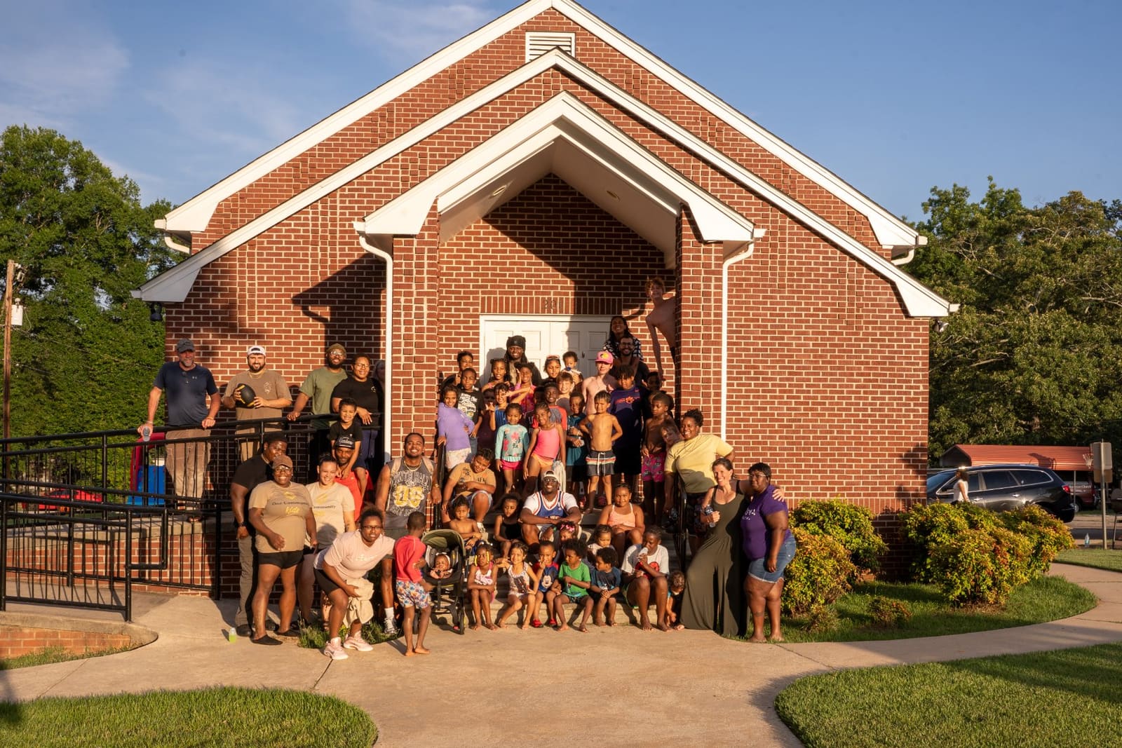 The One Community family in front of the church